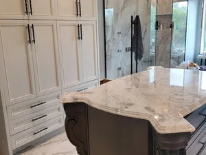 Leathered stone countertop with a carved corbel