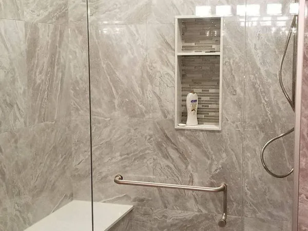 Barrier free shower with a grab bar and bench in a Guelph Arboretum bathroom