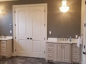 Furniture style vanity under a crystal chandelier
