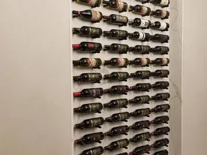 Floor to ceiling wine wall with metal racking